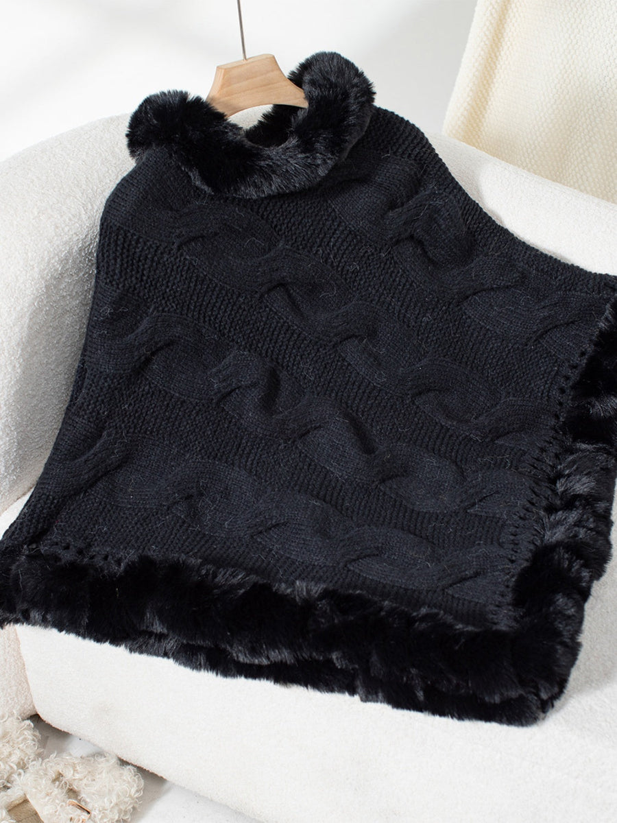 Black cable knit poncho with faux fur trim and collar detail.
