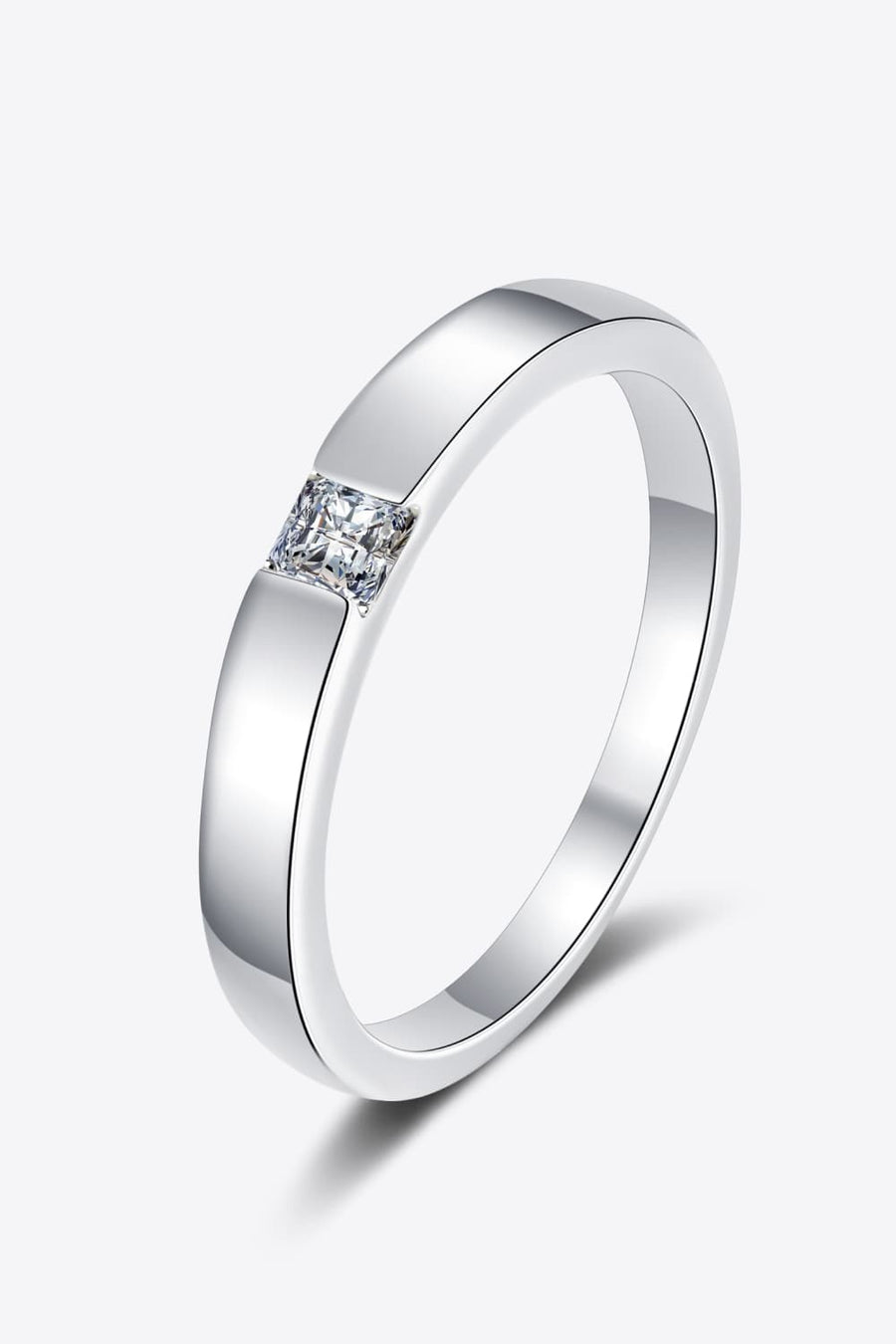 Silver band ring with a single princess-cut solitaire diamond.