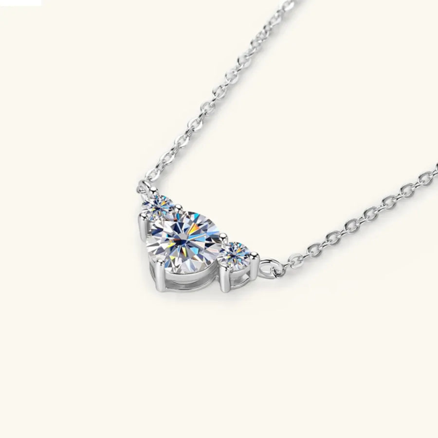 Silver necklace with three sparkling diamonds in a graduated design.