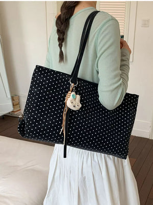 white handbag featuring shoulder straps and polka dot