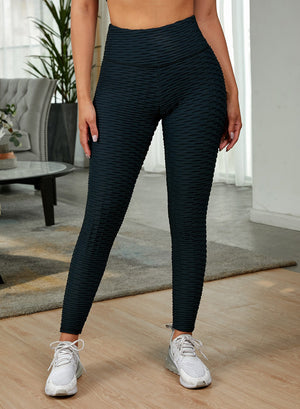 Black textured sculpting high-waist performance leggings with a honeycomb pattern.