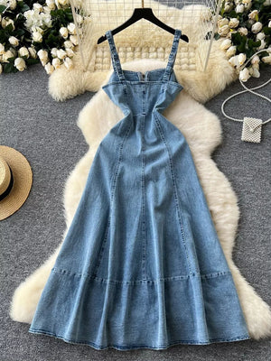Blue denim A-line dress with zipper detail, square neckline, and adjustable straps.