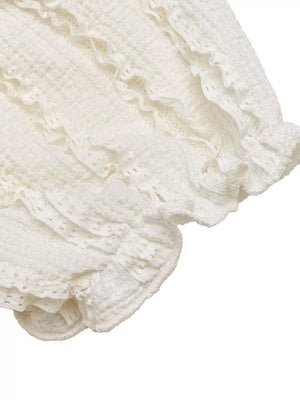 White textured maternity t-shirt with ruched detailing and ruffled puff sleeves.