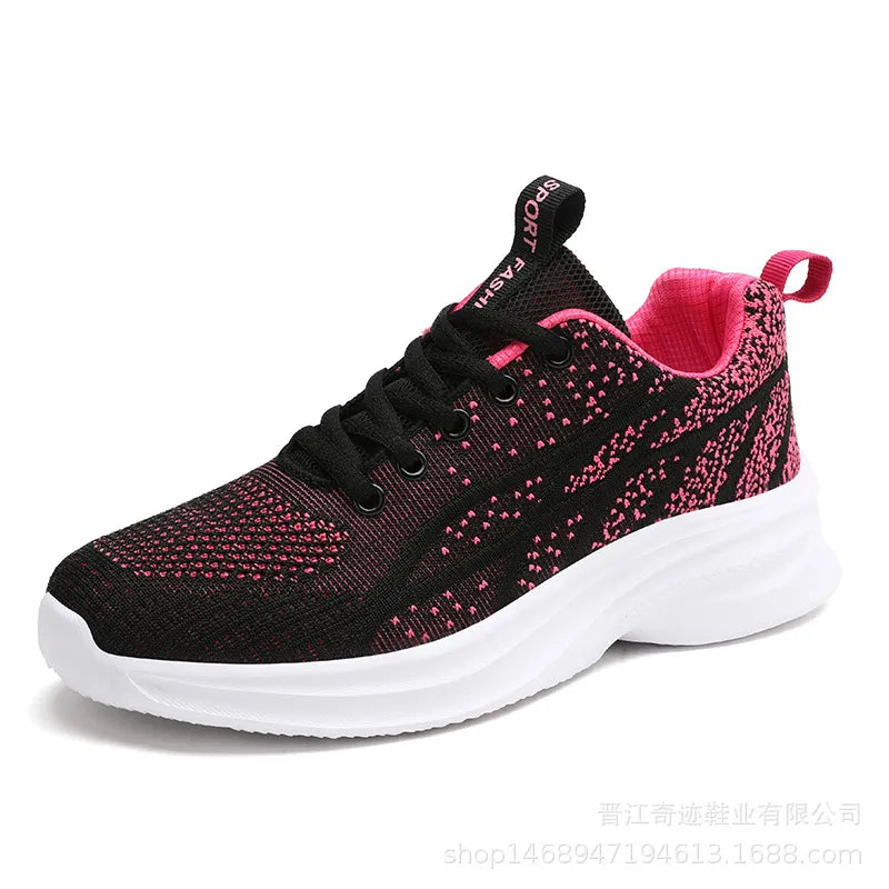 Textured knit performance runners in black with pink accents and white sole.