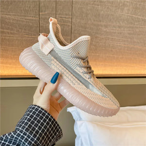 Textured knit platform sneakers in light pink with a translucent pink sole and gray accents.