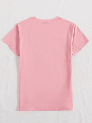 Blush pink t-shirt with iridescent heart and cross appliqué detail on the front.
