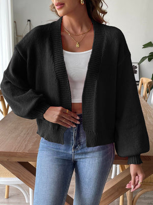 Black balloon sleeve knit cardigan with textured trim and ribbed cuffs.