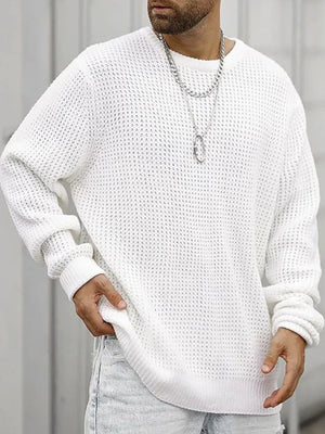 White waffle knit crewneck sweater with relaxed fit and ribbed cuffs.