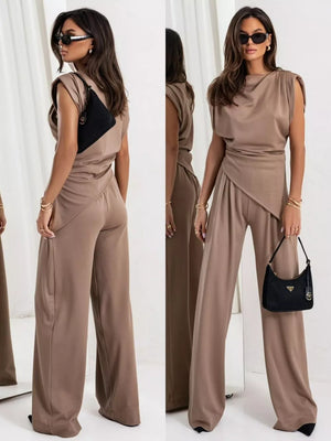 Tan satin cowl neck two-piece set with wide leg pants and asymmetrical draped top.