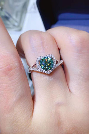 Green heart halo moissanite engagement ring in silver with diamond accents.