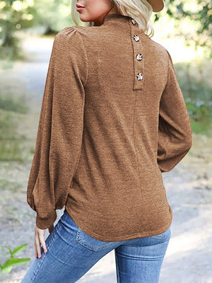 Camel button-back puff sleeve mock neck top with balloon sleeves.