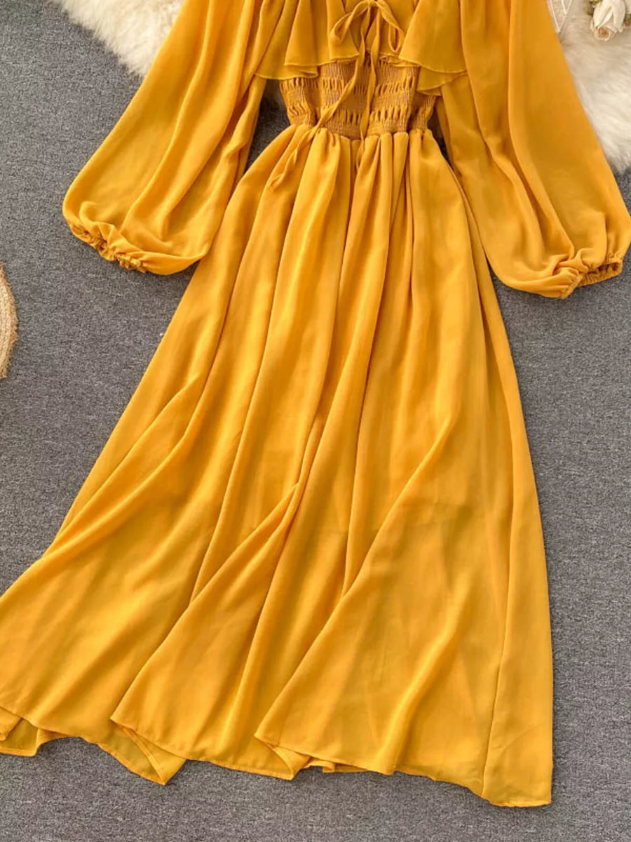 Yellow maternity dress with smocked bodice, ruffled square neck, and balloon sleeves.
