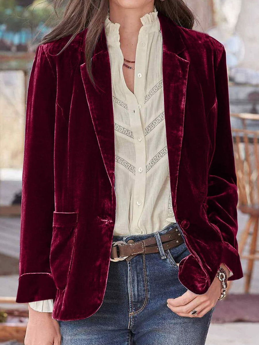 Burgundy velvet blazer with rolled cuff detail and button closure, styled with a white lace-trimmed blouse.