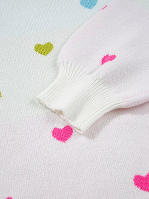 White knit sweater with colorful heart pattern and ribbed cuffs.