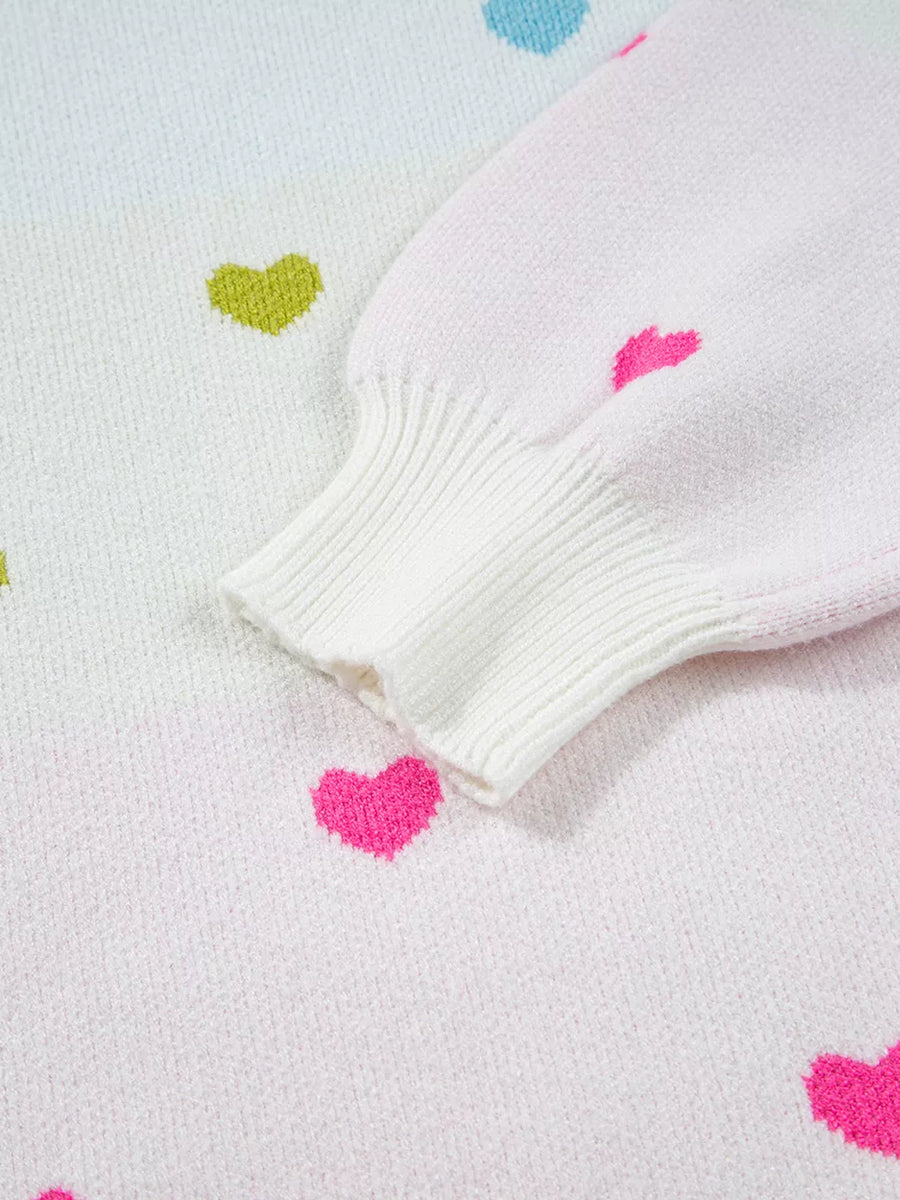 White knit sweater with colorful heart pattern and ribbed cuffs.