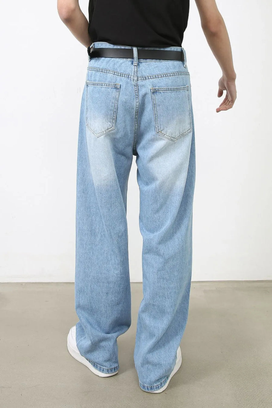 Light blue faded denim baggy jeans with a relaxed fit.