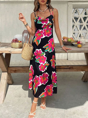 Vibrant floral midi dress with spaghetti straps and a black background.