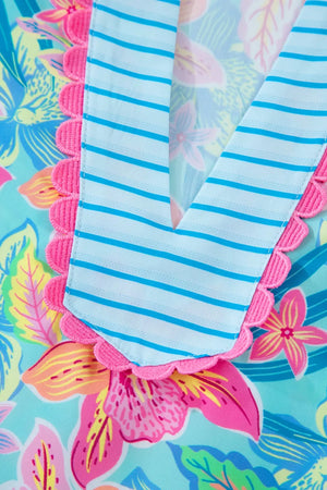 Tropical floral V-neck dress with blue stripes and pink scalloped trim.