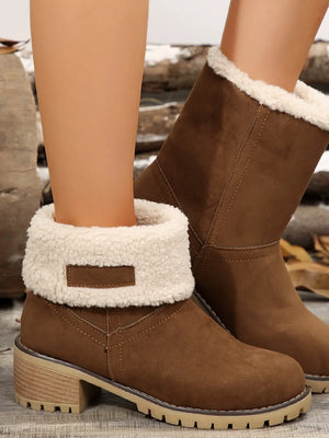 Brown suede ankle boots with cream sherpa trim and block heel.