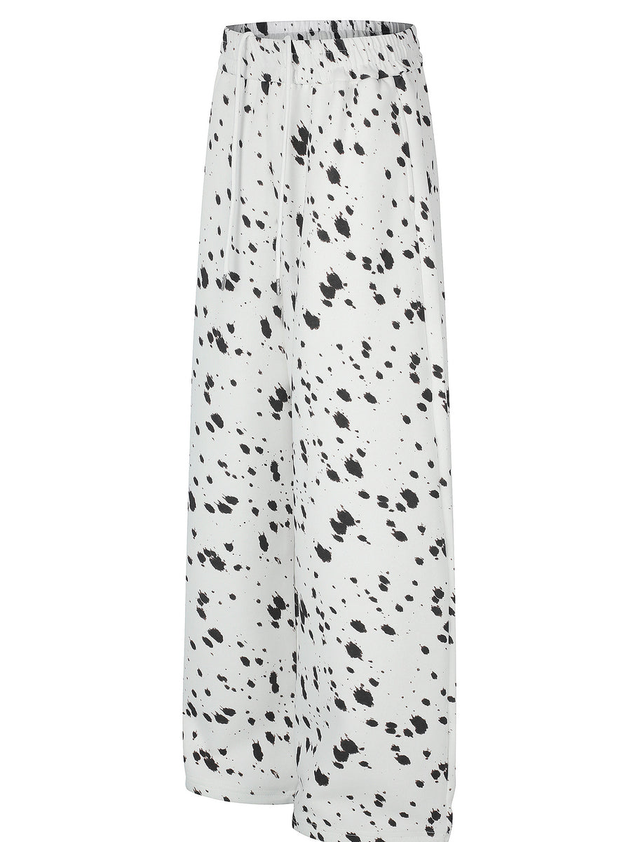 black wide-leg pants featuring elastic waist and paint splatter