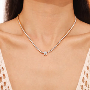 Gold choker necklace with a pavé starburst pendant and delicate crystal accents.