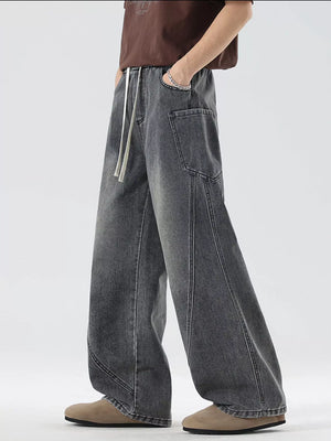 Oversized wide-leg jeans in smoky gray denim with a drawstring waist and vintage-inspired stitching.