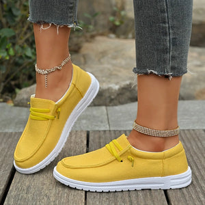 Yellow linen-blend boat shoes with white contrast sole and decorative laces.