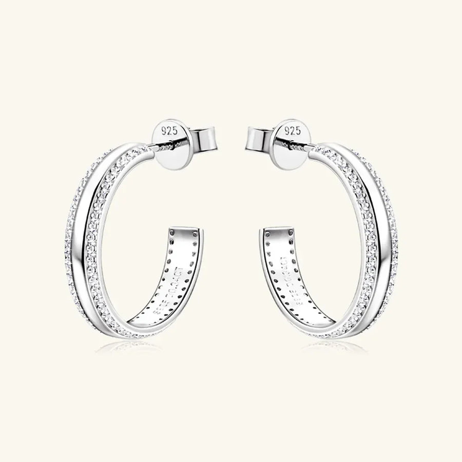 Silver pavé moissanite C-hoop earrings in sterling silver with detailed inner engraving.