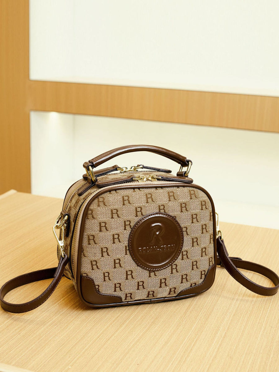 crossbody bag featuring monogram in tan with PU Leather Imported Size & texture