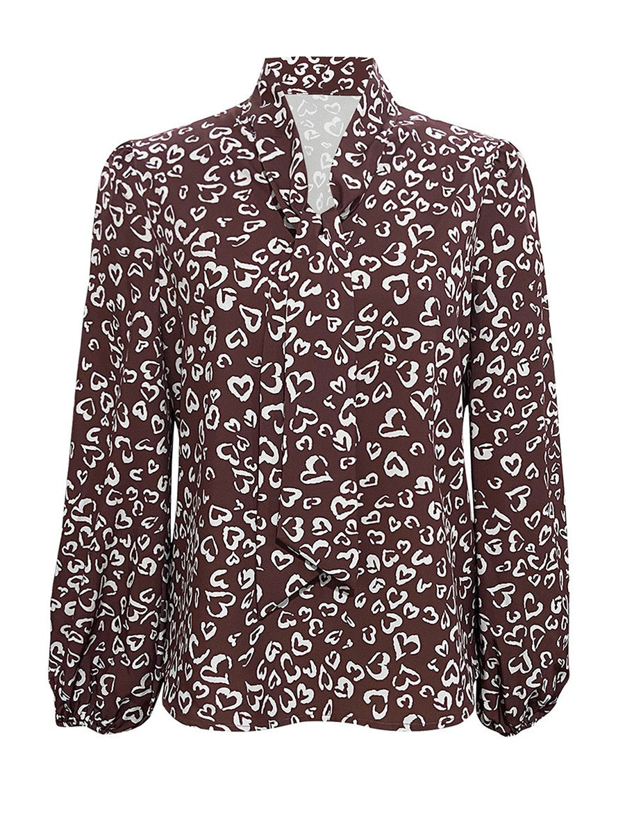 Burgundy blouse featuring bow-tie neck and geometric
