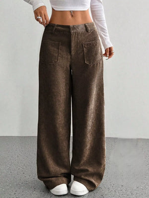 Brown corduroy wide-leg trousers with front patch pockets and a comfortable fit.