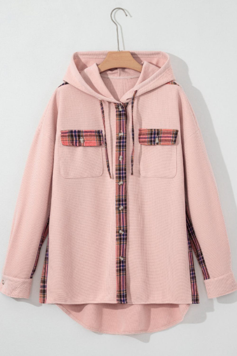 Blush pink waffle knit shacket with plaid trim on pockets and button placket, featuring a hood.