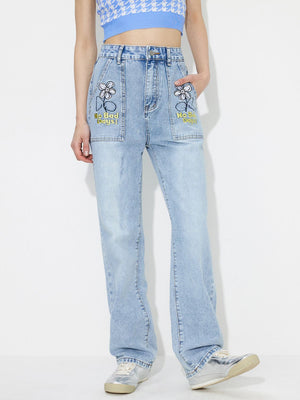 Light wash denim jeans with embroidered flower and "No Bad Days" text on pockets.