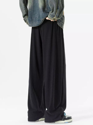 Black relaxed fit drawstring sweatpants with pockets, wide leg.