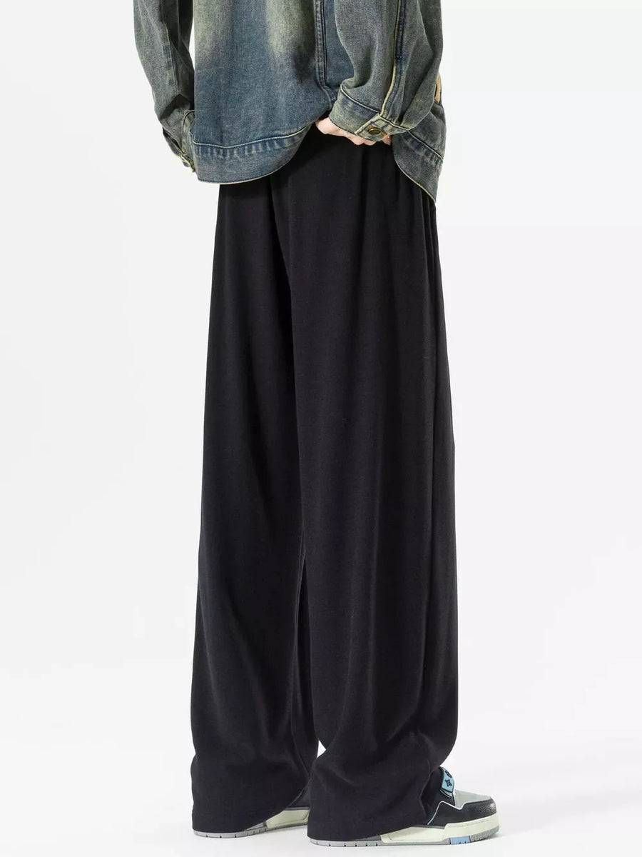 Black relaxed fit drawstring sweatpants with pockets, wide leg.