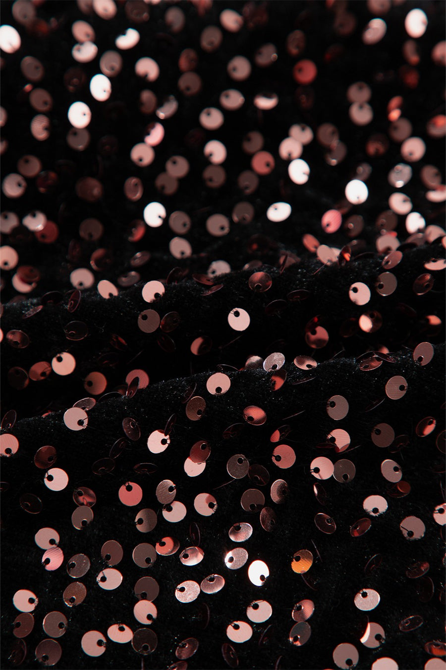 Black sequin backless blouse with rose gold sequins on textured fabric