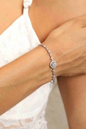 Silver moissanite bracelet with celestial halo and star details on a woman's wrist.