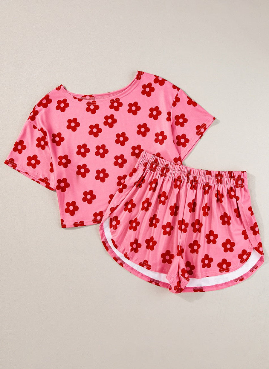 Coral pink floral crop top and shorts set with white trim on shorts.