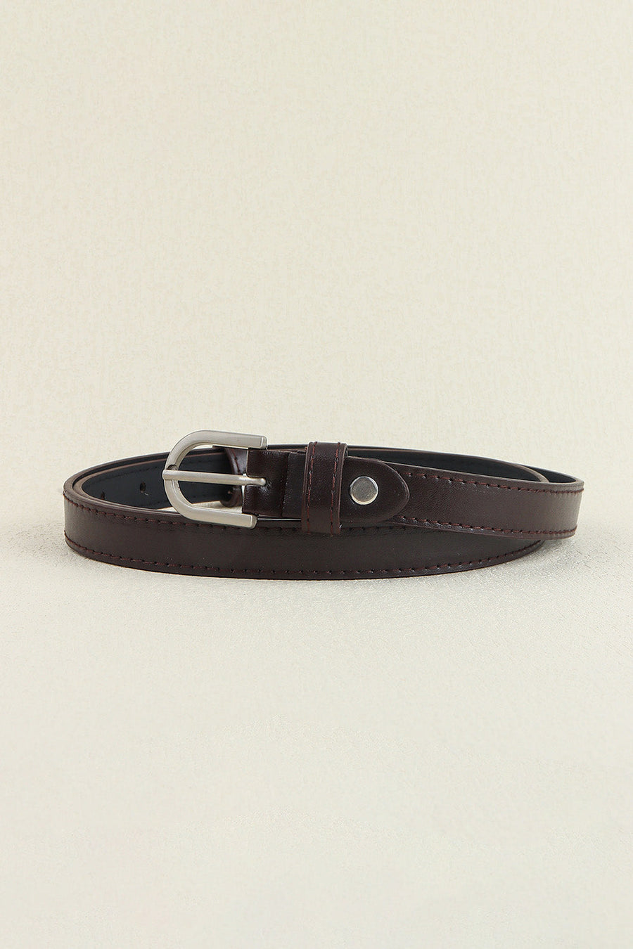Slimline chocolate leatherette belt with silver buckle and tonal stitching.