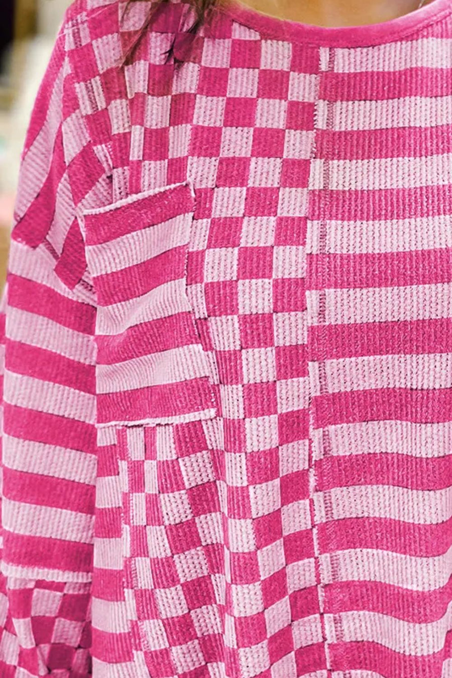 Hot pink knit top with asymmetrical checkered and striped patchwork design