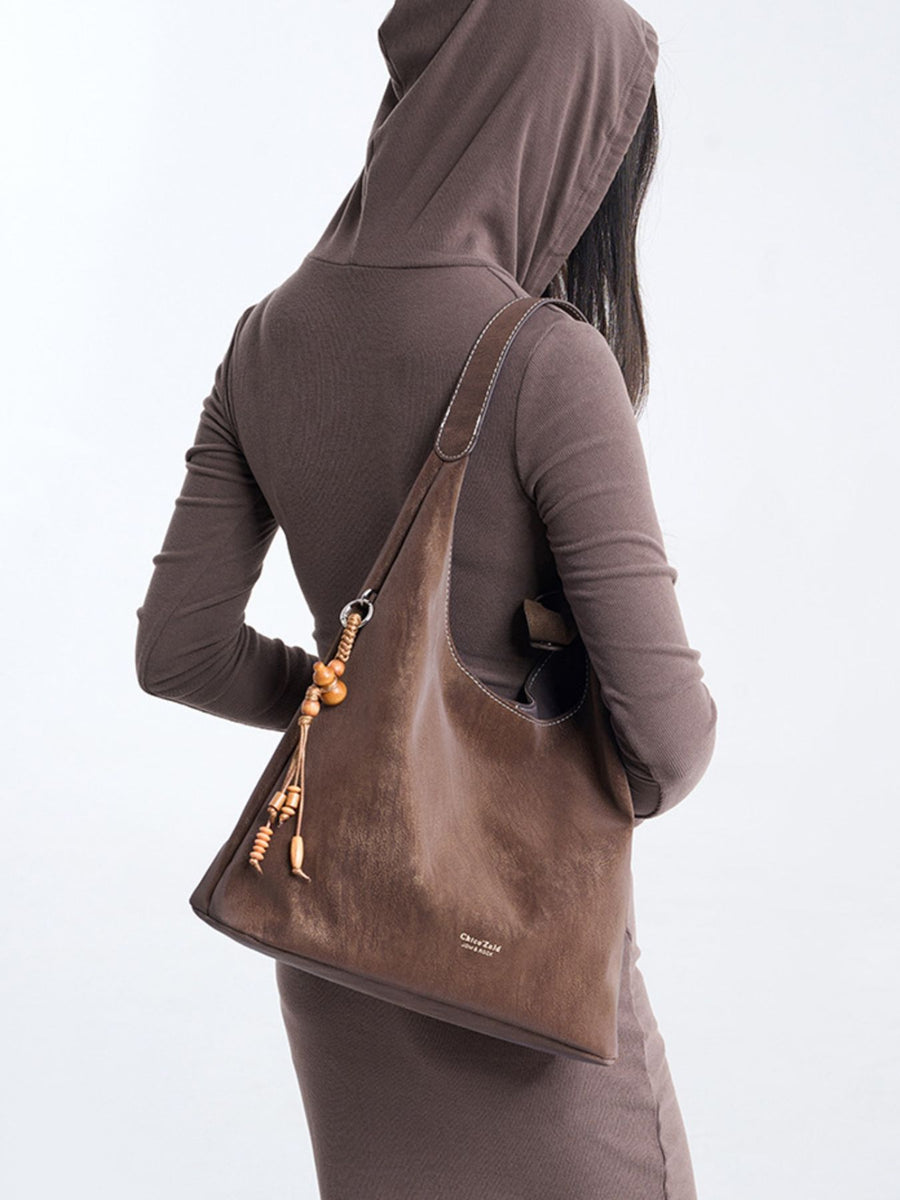Suede Hobo Shoulder Bag With Tassel in Brown with decorative tassel