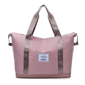 Dusty Pink expandable travel tote with contrast trim and dual handles.
