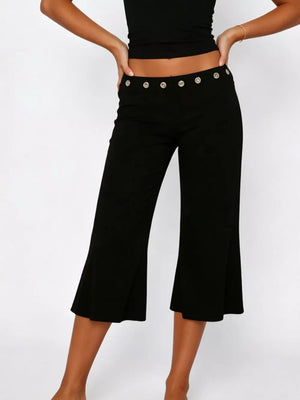 Black flared hem capri pants with button detail at waist