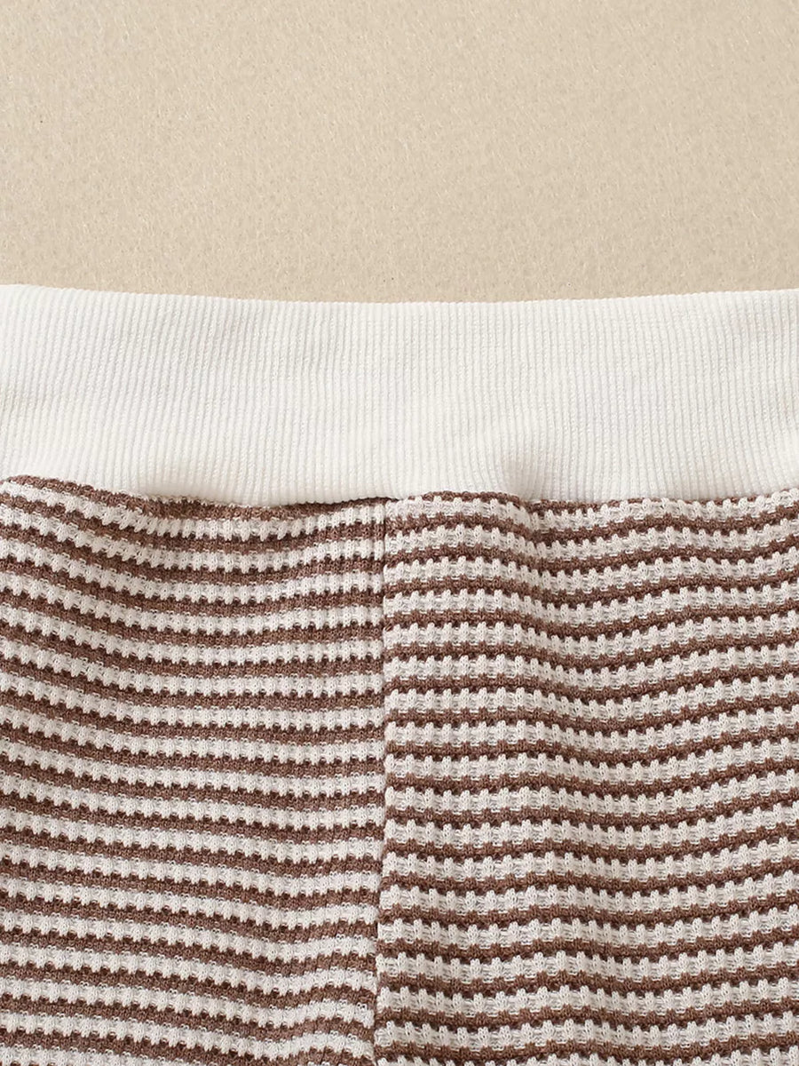 Baby knit set with brown and white stripes and a white ribbed waistband.