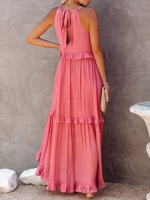 Pink ruffled maxi dress with tie back and tiered skirt.