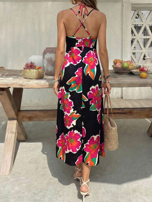 Vibrant floral midi dress with spaghetti straps and crisscross back detail.