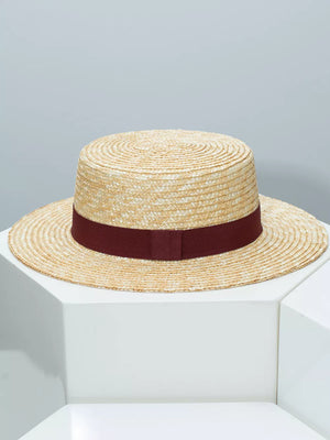 Women's straw boater hat with a wine red ribbon band