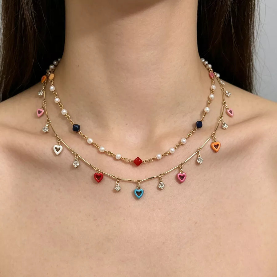 white necklace featuring layered and heart