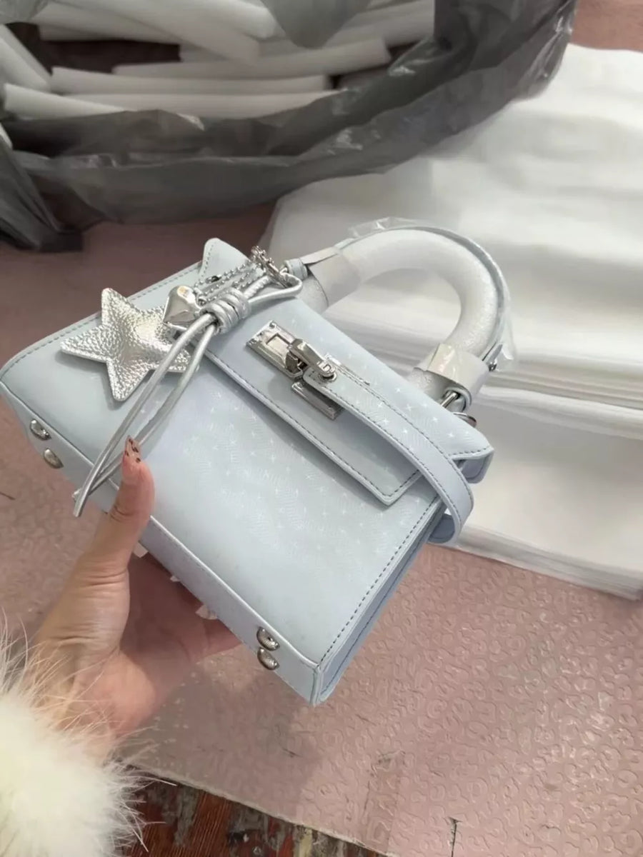Blue embossed mini handbag with star charm and silver hardware