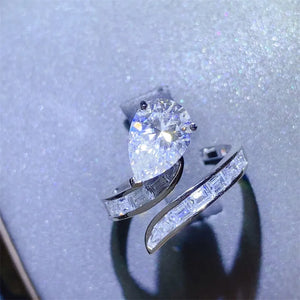 Silver bypass ring with pear cut diamond and baguette accents